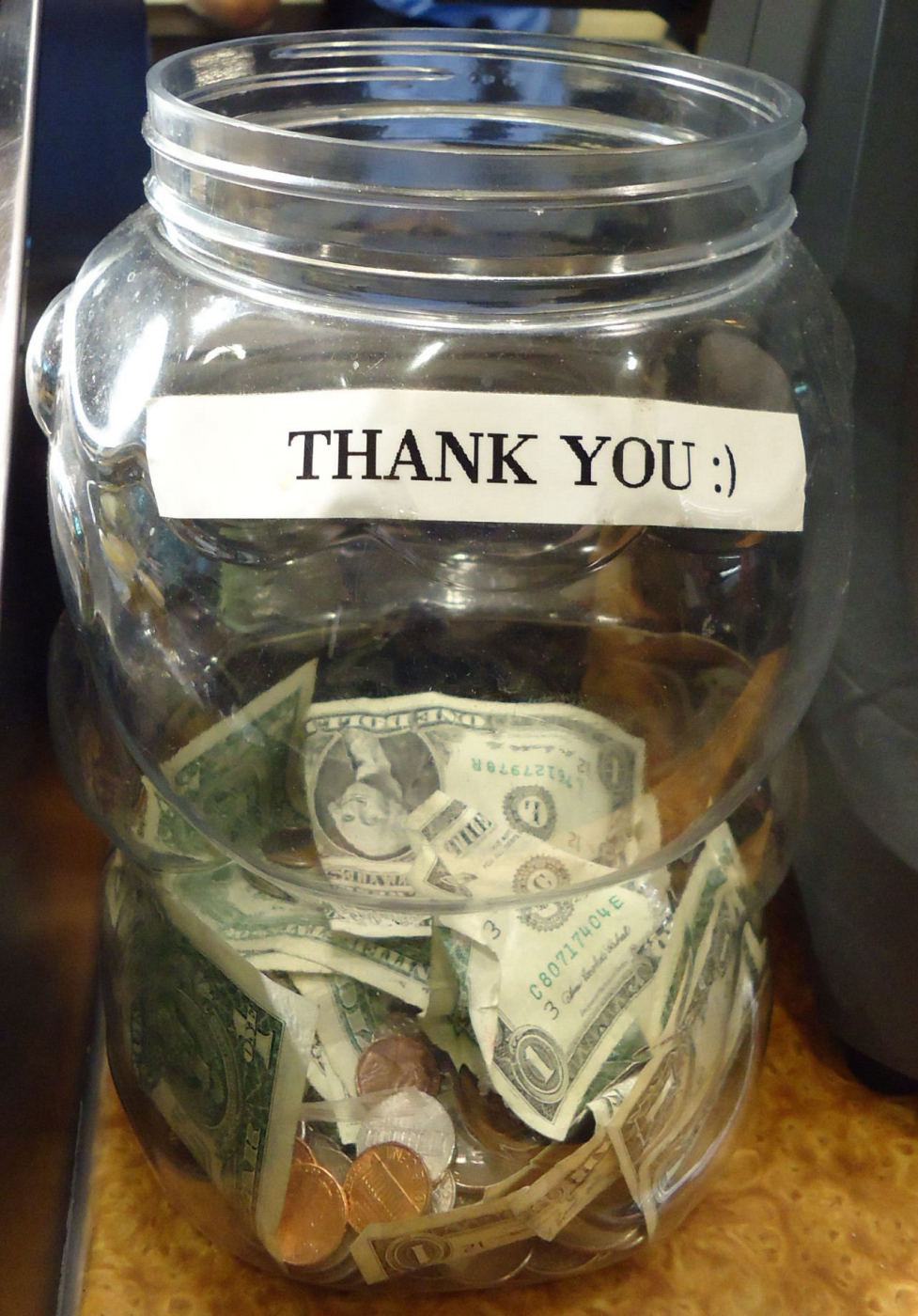 A jar for tips on a counter in an American restaurant