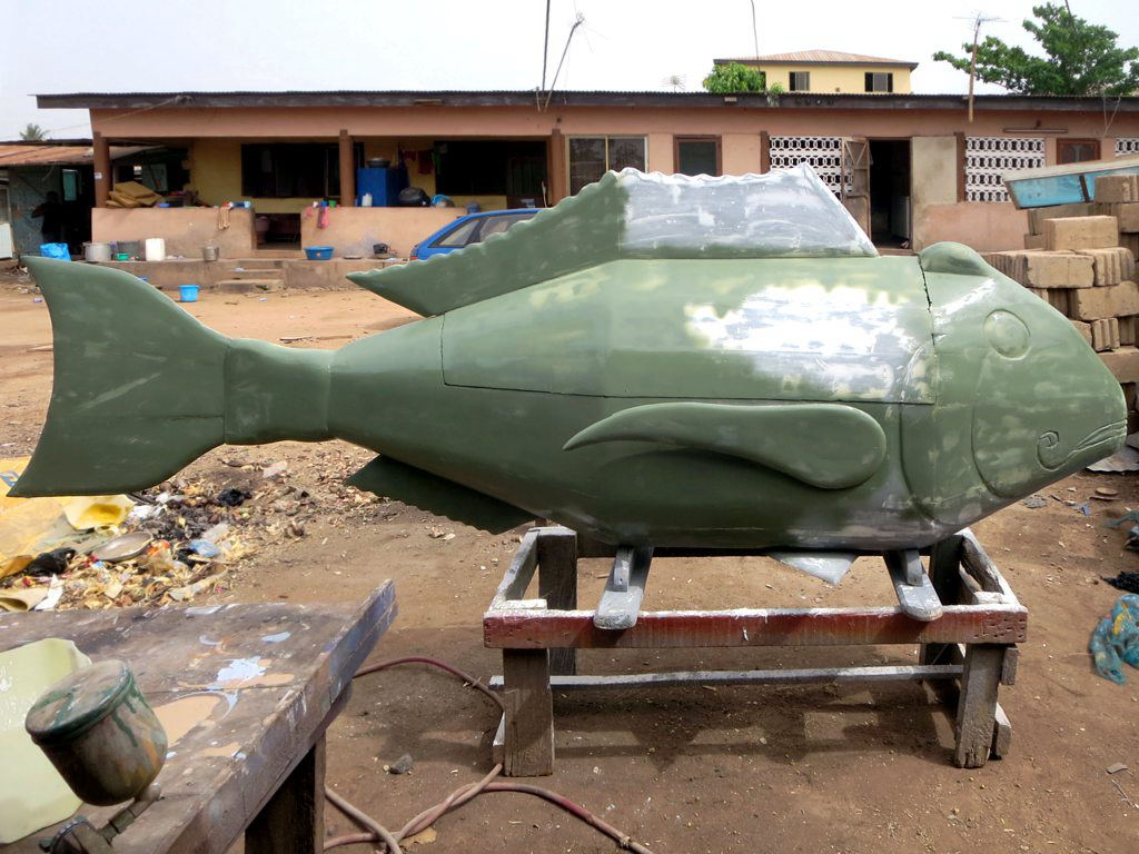 A fish-shaped fantasy coffin under construction in a Ghanaian workshop